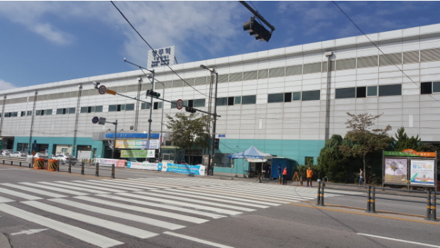 Leave the station and cross the street to take the bus.